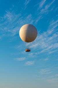 Low angle view of hot air balloon against blue sky