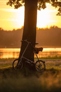 Close-up of bicycle against sunset
