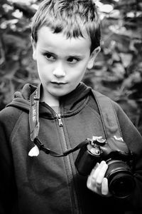 Portrait of boy photographing in black and white 