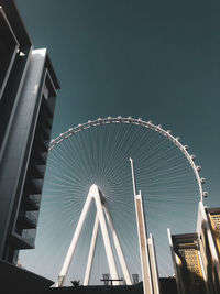 Low angle view of illuminated ferris wheel against sky