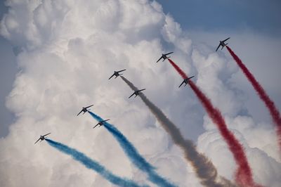 Low angle view of airshow against sky