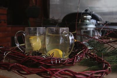 Close up of drinks by wreath on table