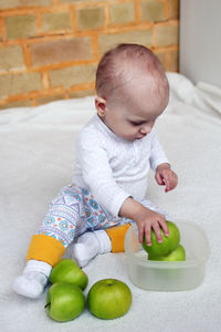 Cute baby girl sitting on table