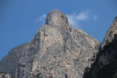 Low angle view of rocky mountains against sky