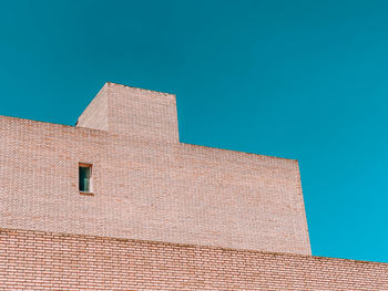 Low angle view of building against blue sky