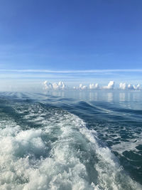 Aerial view of sea against blue sky