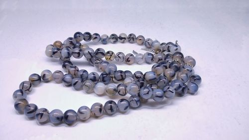 High angle view of necklace on white table