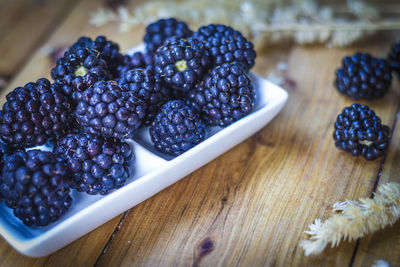 High angle view of blackberries in plate on table