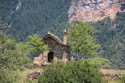 Old house on field against mountains