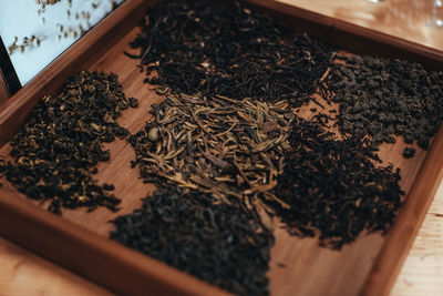 Various types of tea leaves in a wooden box. organic and natural herbs