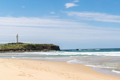 View of beach against cloudy sky