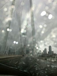 Tilt image of bridge against sky in city