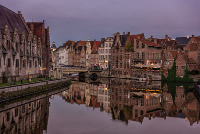 Scenic view of buildings in city reflected in canal