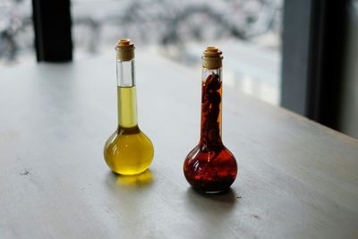 High angle view of aromatherapy oils in bottles on table