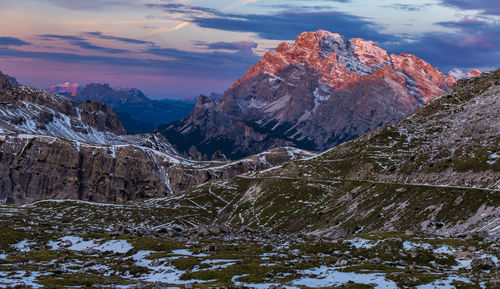 Scenic view of snowcapped mountains against sky during sunset