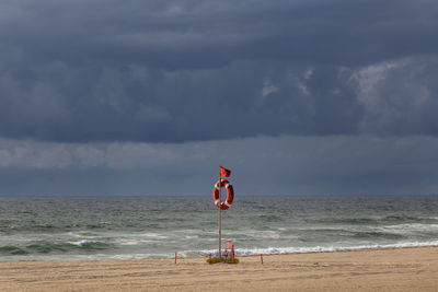 Lifeguard hut at sea against sky