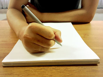 Close-up of hand holding book