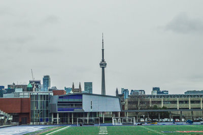 Buildings in city against cloudy sky