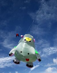 Low angle view of flying hippo balloon against sky