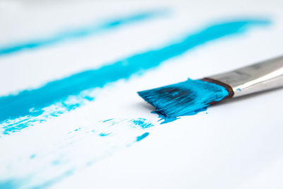 High angle view of blue paint on table