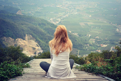 Rear view of woman looking at mountain landscape