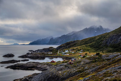 Scenic view of sea and mountains against sky