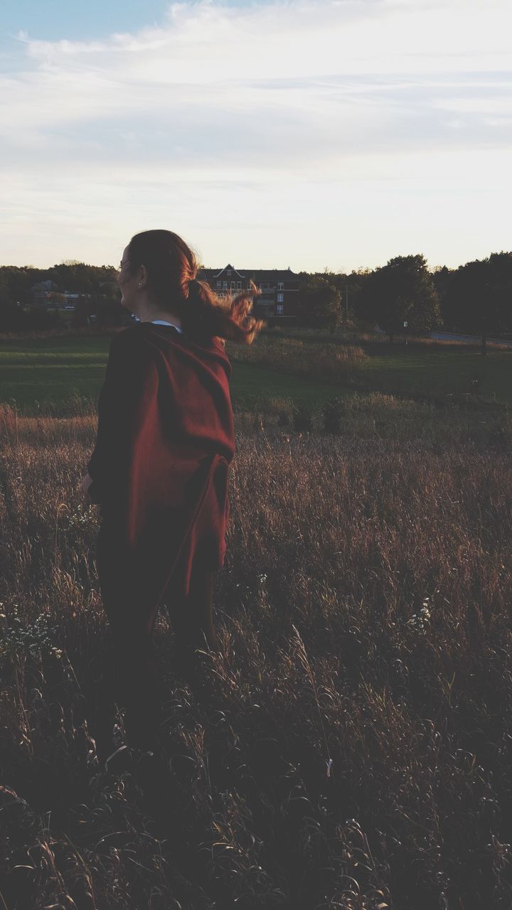 field, sky, landscape, lifestyles, leisure activity, casual clothing, standing, rear view, full length, grass, tranquility, nature, cloud - sky, tranquil scene, rural scene, three quarter length, men, outdoors