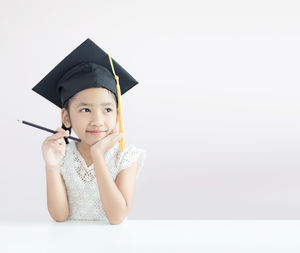 Portrait of a smiling young woman against white background