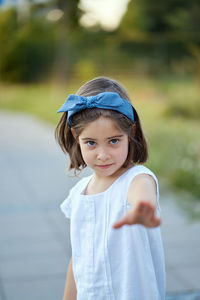 Portrait of cute girl standing in park