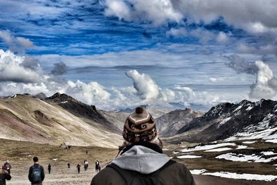 Portrait of woman with snowcapped mountains against sky