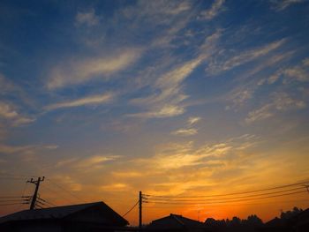 Low angle view of silhouette buildings against sky during sunset