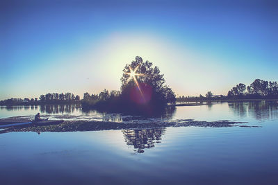 Scenic view of lake against sky at sunset