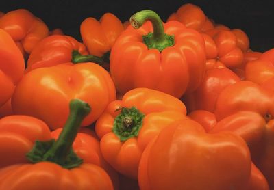 Close-up of orange bell peppers for sale in market