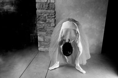 High angle view of ballerina wearing shoes against wall