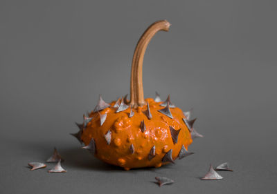 Close-up of pumpkin against orange background