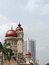 Low angle view of buildings in city against sky