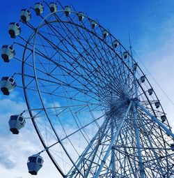 Low angle view of ferris wheel against sky