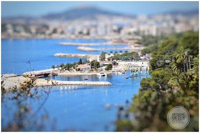 Tilt-shift image of town by sea