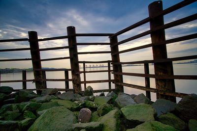 Rocks by sea against sky