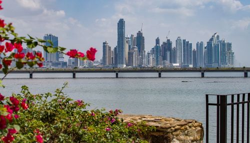 Scenic view of lake by buildings against sky