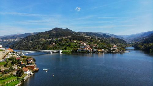 Scenic view of lake by buildings against sky