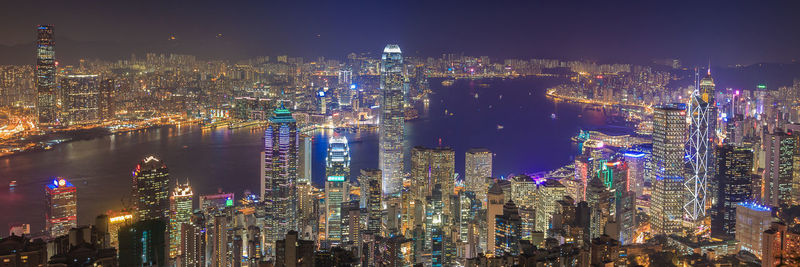 Illuminated cityscape against sky at night