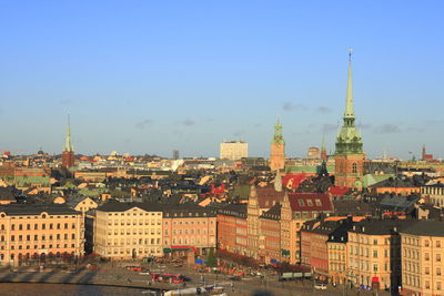 High angle view of buildings against blue sky