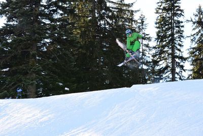 Person skiing on mountain against sky