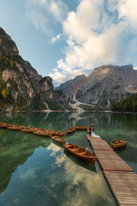 Scenic view of lake by mountains against sky