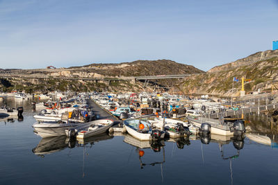 Boats moored in lake against sky