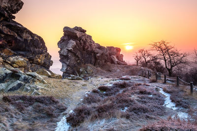 Scenic view of snow covered land during sunset