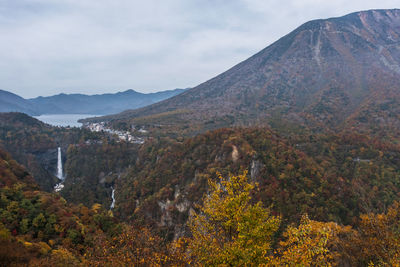 Countryside landscape against mountain range