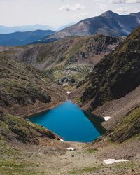 High angle view of lake amidst mountains against sky