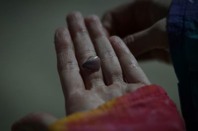 Cropped image of hand looking through window